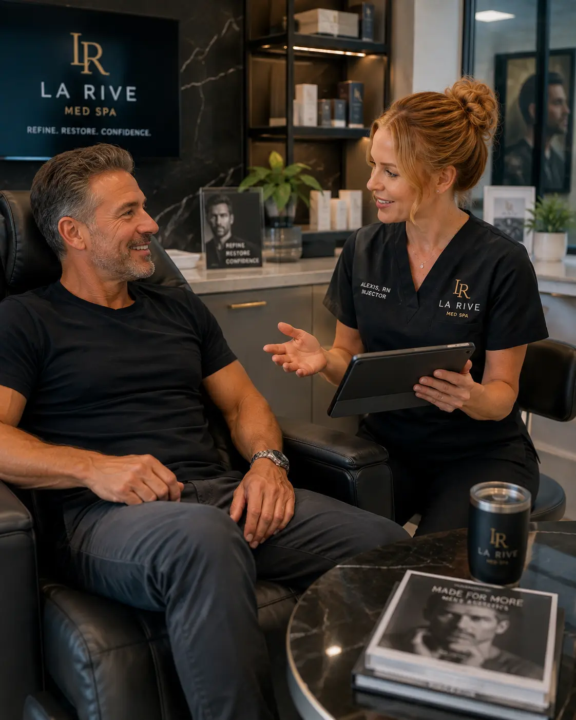 A male client in consultation with a La Rive injector, reviewing options on a tablet